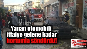 Yanan otomobili itfaiye gelene kadar hortumla söndürdü